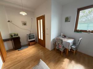 a living room with a table and a television at Apartments Avram in Vršac