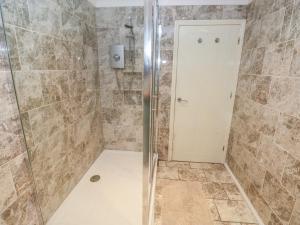 a shower with a glass door in a bathroom at Annexe Meadows Farm in Swansea +16 photos