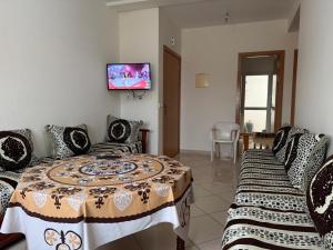 a room with two beds and a flat screen tv at RiF Services in Al Hoceïma
