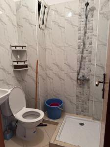 a bathroom with a shower with a toilet and a sink at RiF Services in Al Hoceïma