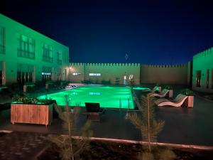 a large swimming pool in a building at night at Lazgi Boutique & Spa Hotel in Khiva