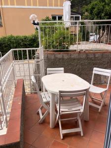 a white table and chairs on a patio at Verdazzurra in Bergeggi