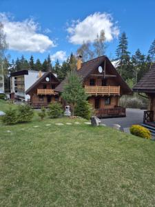 a large log home with a large yard at Zruby Liptovský Ján in Liptovský Ján