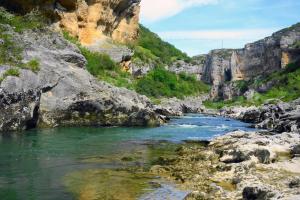 a river in a canyon with rocks and trees at Casa Rural Garcés in Lumbier