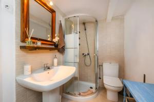 a bathroom with a sink and a shower and a toilet at Cel Pins in Portopetro +33 photos