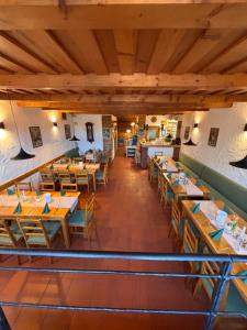 an empty restaurant with wooden tables and chairs at Penzion Šaldorf in Nový Šaldorf