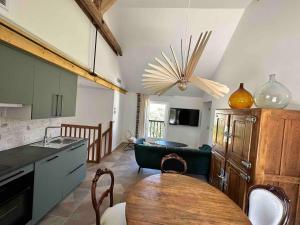 a kitchen with a table and a living room at Duplex des montains in Loches +30 photos