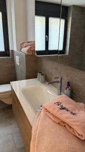 a bathroom with a sink and a mirror and a towel at Bergperle in Grächen +40 photos