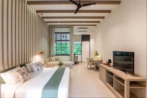 a bedroom with a large bed and a living room at Flora Creek Chiang Mai in Hang Dong +45 photos