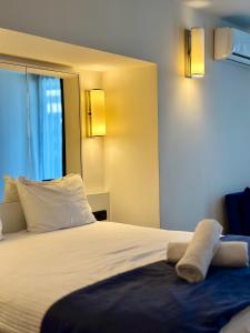 a hotel room with a bed with two towels on it at Batumi Best View in Batumi +58 photos