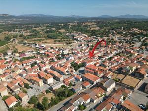 a red kite is flying over a city at ANTICHE TERRE Di GALLURA in Monti