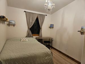 a bedroom with a bed and a desk and a window at River View Upstairs Apartment in Kenai