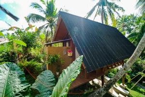 a house with black solar panels on the roof at Ubud Jungle Stay - Mahari by WAHM in Ubud