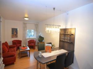 a living room with a table and chairs and a dining room at Apartment near ski area in Wehrstapel in Sauerland in Meschede