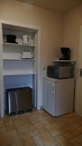 a room with a small refrigerator and a shelf at Adele in Zingst