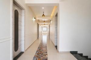 a corridor of a building with a tile floor and a hallway at FabHotel Kalptaru in Pune