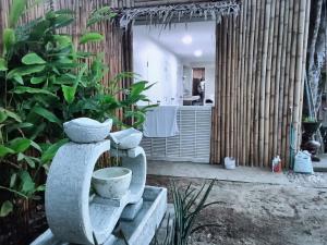 a bathroom with a toilet in the middle of a room at Ladybugs hostel sunset in Taling Ngam Beach