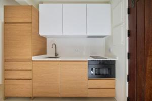 a kitchen with a sink and a stove at Casa Redonda by Villas Aura - Retreat 2 in Aroeira