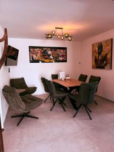 a dining room with a wooden table and chairs at Parkside Apartments Rust in Rust