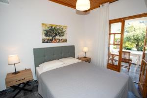 a bedroom with a large bed and a window at Nefeli Studios in Parga