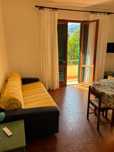 a bedroom with a bed and a table and a window at Casavacanze Zeus in Marciana Marina