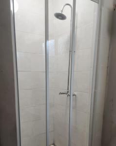 a shower with a glass door in a bathroom at Vumasky self catering in Ladysmith