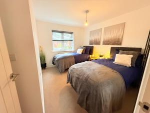 a bedroom with two beds and a window at The Vine in Powick