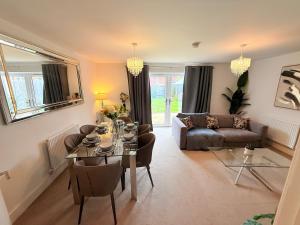 a living room with a table and a couch at The Vine in Powick