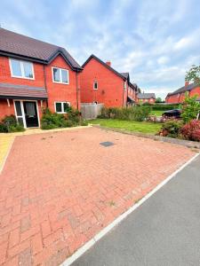 a brick driveway in front of a house at The Vine in Powick