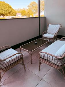 two chairs and a coffee table on a balcony at Parkside Apartments Rust in Rust