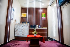 a waiting room with a table with a flower on it at V V Residency in Thanjāvūr