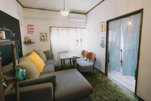 a living room with a couch and a table at Kominka Hakone Entire Traditional House in Hakone
