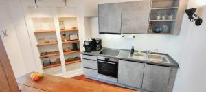 a kitchen with a sink and a stove top oven at Brasseriehof Historisches Fachwerkhaus in Flensburg 115 m2 Innenhof Parkplatz in Flensburg