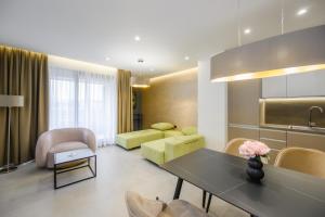 a kitchen and living room with a table and chairs at Aurelia Residence in Metković +59 photos
