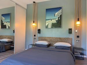 a bedroom with a bed with two pillows on it at Studio Luxe + jardin et terrasse in Pontoise