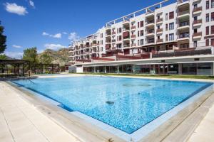 a swimming pool in front of a building at Jazmin ID300 in Villanueva de Río Segura