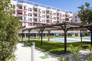 a large apartment building in front of a park at Jazmin ID300 in Villanueva de Río Segura