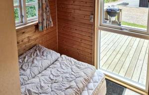 a room with a bed in front of a window at Cozy Apartment In Farsø With Heated Swimming Pool in Farsø +3 photos