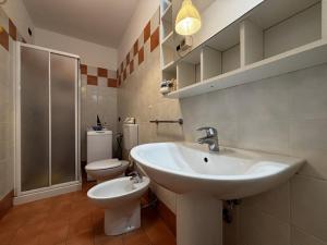 a bathroom with a sink and a toilet at Residence Mairen a pochi passi dal mare in Rosolina Mare +119 photos