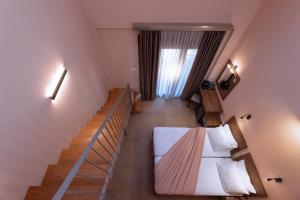 a room with a staircase and a bed in a room at Old Nikiti's Hotel in Nikiti +13 photos