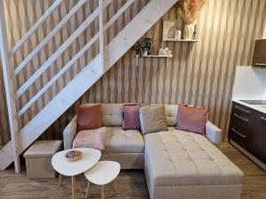 a living room with a couch and a table at Apartmán Sophia 6 in Velké Losiny