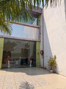 a lobby of a building with plants in front of it at The Royal Vintage Resort in Majhola
