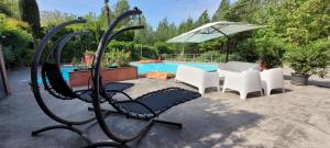 a chair and an umbrella next to a pool at Lbkn in Toulouse +21 photos
