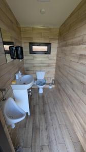 a bathroom with two sinks and a toilet at Kupiškėnų Starkėnas in Palėvenėlė +29 photos