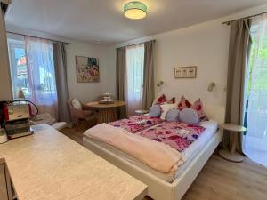 a bedroom with a large bed and a table at Ferienwohnungen am See _ Hinterseer in Schliersee +19 photos