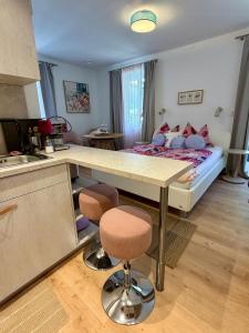 a kitchen with a table and a bed in a room at Ferienwohnungen am See _ Hinterseer in Schliersee