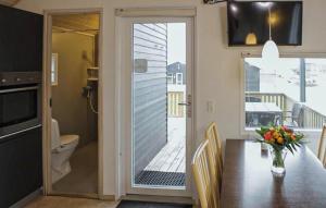 a dining room with a table and a sliding glass door at Nice Apartment In Farsø With Heated Swimming Pool in Farsø