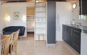 a room with a loft bed and a kitchen at Nice Apartment In Farsø With Heated Swimming Pool in Farsø
