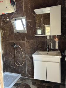 a bathroom with a sink and a mirror at Villa Neimi in Ksamil +23 photos