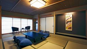 a living room with a table and chairs in a room at Notoya in Komatsu +39 photos